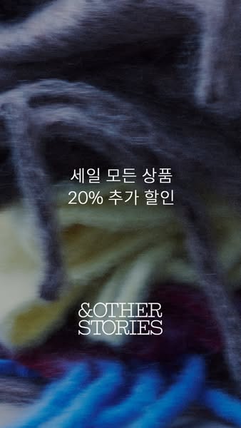 An ad by &Other Stories featuring an additional 20% discount on all sale items. The ad features an image of a pile o