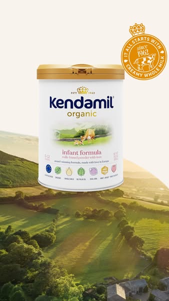 This ad features Kendamil Organic infant formula, presented against a backdrop of rolling green hills. The product packa