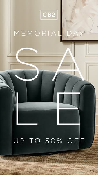 This image ad for CB2 promotes a Memorial Day sale with up to 50% off. The ad features a close-up shot of a blue velvet