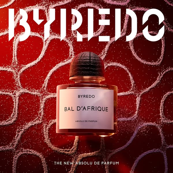 This ad features Byredo's Bal d'Afrique Absolu de Parfum. The product is centered on a red background with a des