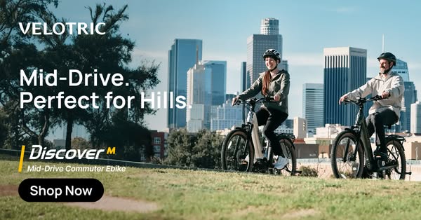 This image ad for Velotric e-bikes features two people riding the brand's mid-drive commuter e-bikes with a city sky