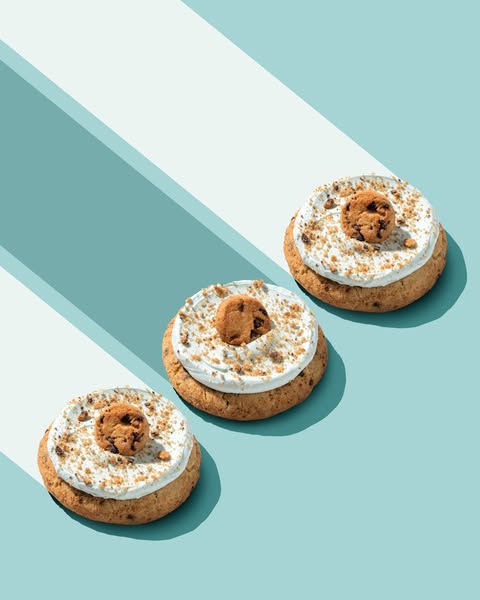 This ad features a visually appealing arrangement of three cookies stacked on top of each other. Each cookie is topped w