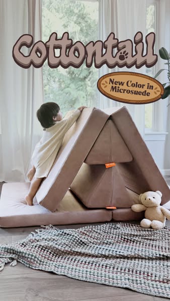 Ad for Cottontail's new color of microsuede play couch for toddlers. The ad shows a young child climbing on the toy.