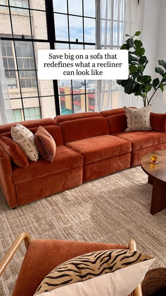 This ad features a plush, orange modular sofa in a modern living room. The headline emphasizes savings and redefines the