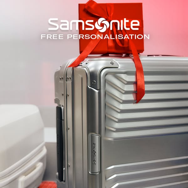 This ad showcases a Samsonite suitcase with a red gift box on top, promoting free personalization.