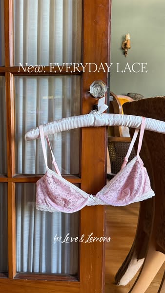 This ad showcases a pink lace bra from the brand For Love & Lemons. The bra is displayed on a hanger against a neutr