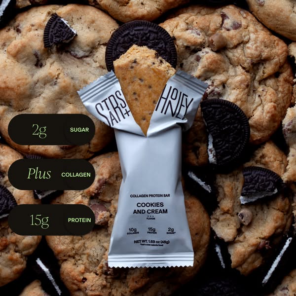 This ad features a protein bar surrounded by cookies. The ad highlights the protein content and low sugar content of the
