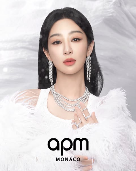 This ad showcases APM Monaco jewelry, featuring a model adorned with the brand's earrings, necklaces, and rings agai