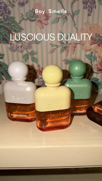 This image ad showcases three different Boy Smells fragrances, each with a unique color scheme, set against a floral wal