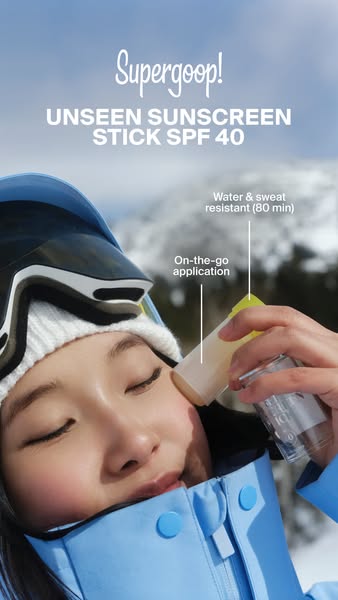 This ad showcases the Supergoop! Unseen Sunscreen Stick SPF 40 being applied to a woman's face while she is on the g