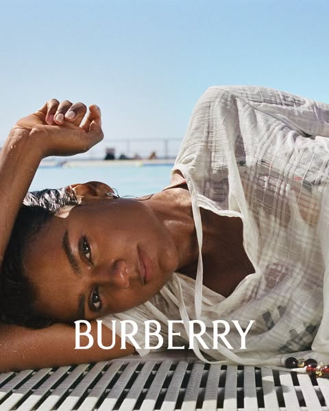 This image ad features a dark-haired woman reclining in swimwear and a white cover-up near a pool, overlaid with the BUR