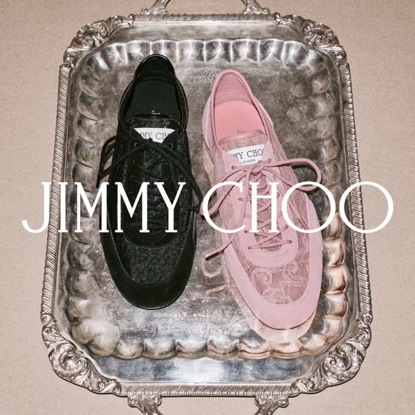 This ad features two Jimmy Choo sneakers, one black and one pink, displayed on a silver tray. The brand name is prominen