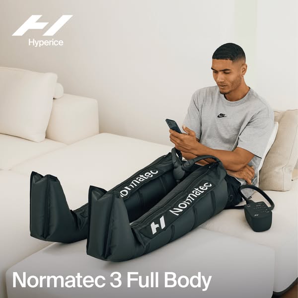 The ad shows a man relaxing on a couch using the Normatec 3 Full Body system. The product is the focus of the ad.