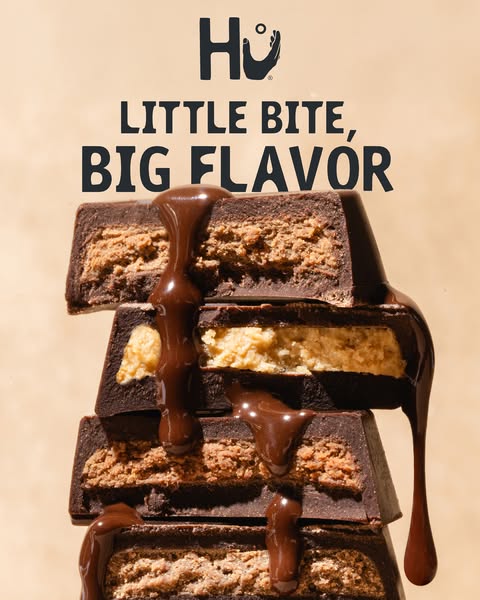 This image ad for Hu chocolate features a close-up stack of their peanut butter filled chocolate bars. The bars are topp