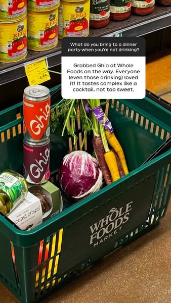 This ad features a photo of a Whole Foods shopping basket containing Ghia non-alcoholic beverages and fresh produce. The