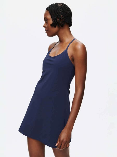 This ad features a woman wearing a navy blue exercise dress. The ad focuses on the fit and style of the dress.