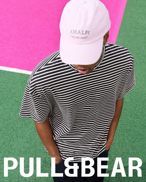 This image ad showcases a person wearing clothing and a baseball cap from Pull & Bear against a vibrant backdrop. Th