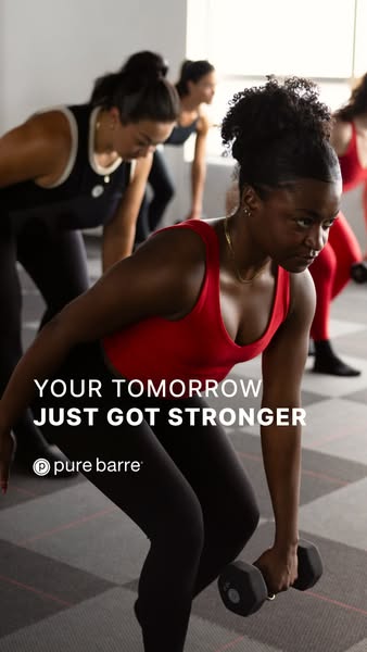 This image ad for Pure Barre features a group of women in a barre class, with the focus on a woman in the foreground lif
