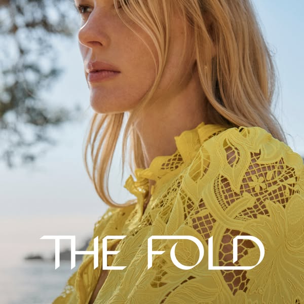 This ad for The Fold features a fashionable woman in a yellow dress, emphasizing the brand's association with sophis