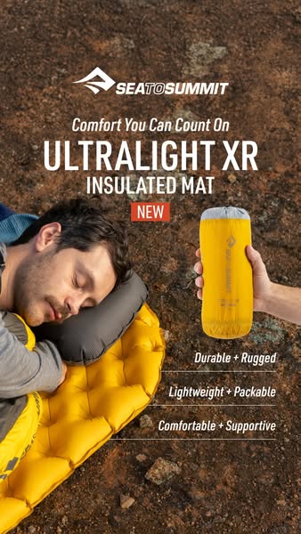 This ad for Sea to Summit's Ultralight XR Insulated Mat features a man resting comfortably on the mat outdoors. The 