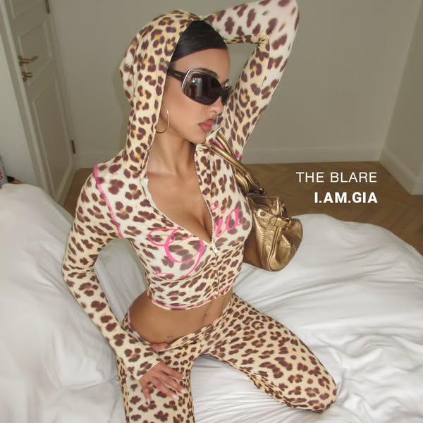 This ad features a model wearing a leopard print sweatsuit from I.AM.GIA. The ad is a product showcase.