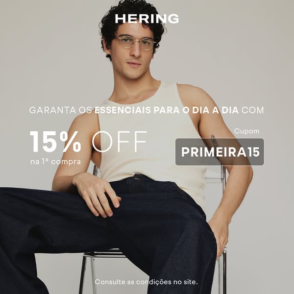 An advertisement for Hering, showcasing a man wearing a tank top and jeans, offering 15% off the first purchase with a c