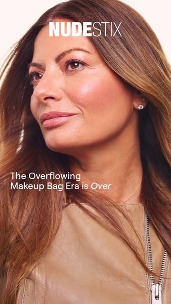 This ad for Nudestix features a close-up of a woman with long brown hair and a tan leather jacket. The ad copy states, &