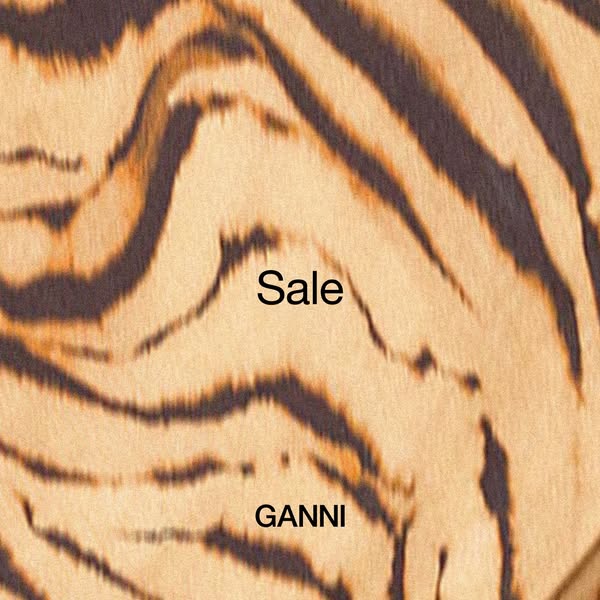 This image ad features a close-up of a tiger-striped pattern with the word "Sale" in the center and the brand 