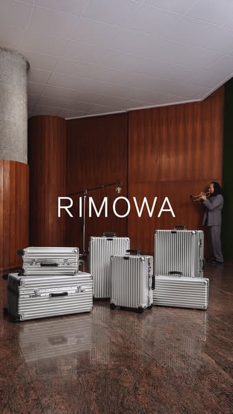 This image ad showcases Rimowa luggage in a stylized setting with a trumpet player. The minimalist composition highlight