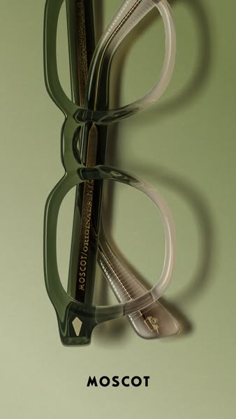 This ad features an image of MOSCOT eyeglasses on a solid green background. The ad highlights the brand's heritage a
