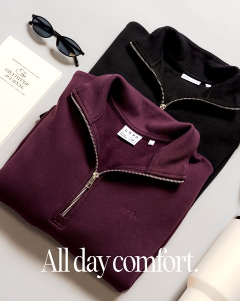 An image ad showcasing LSKD half zip pullovers alongside accessories such as sunglasses, a water bottle, and a gratitude