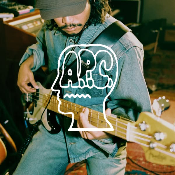 This ad shows a musician playing a bass guitar with a large, white graphic overlay of the Brain Dead logo. The advertise