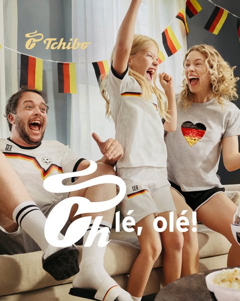 This image ad showcases a family excitedly watching a soccer game. The family is wearing clothing with German flag themi