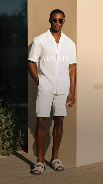 This image ad features a male model wearing a Mauvais linen shirt and shorts set. It highlights the brand's clean ae