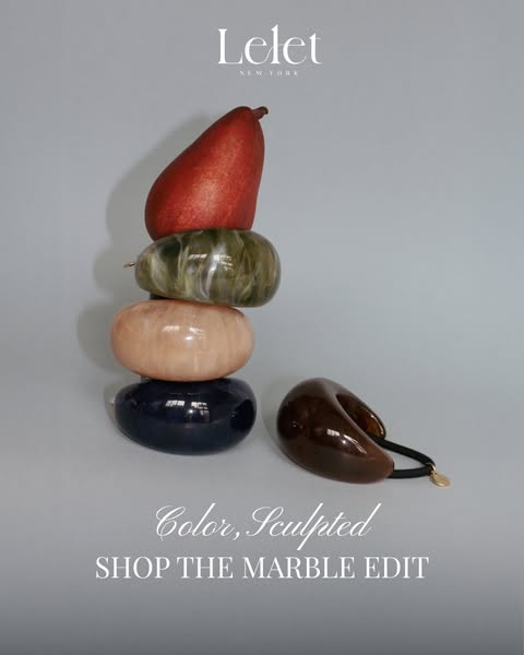 This image ad for LELET NY features a stack of marble-like hair accessories, emphasizing the brand's focus on color 