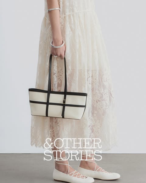 This ad showcases a tote bag from & Other Stories. The ad features a model wearing the bag with a dress and flats fr