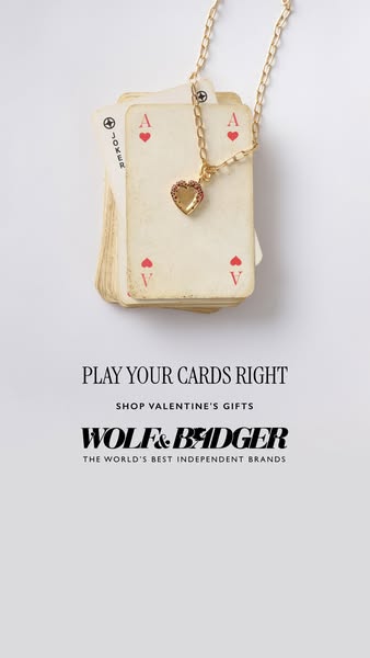 An image ad for Wolf & Badger promotes Valentine's Day gifts. It features a stack of playing cards with a gold h