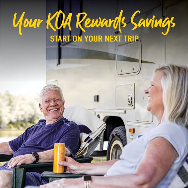 This image ad for KOA rewards program features a smiling couple relaxing outside their RV in a scenic setting, with the 