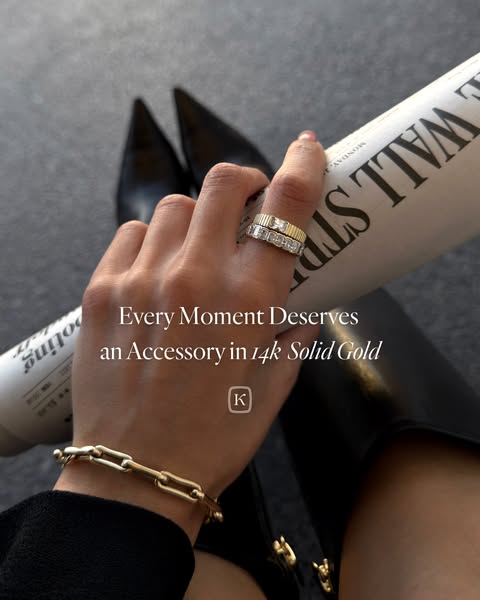 An image showcasing two gold rings and a bracelet on a woman's hand. The ad promotes the idea that every moment dese