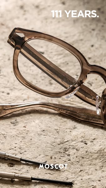 The ad showcases a close-up view of Moscot eyewear, highlighting the brand's 111-year history. The visual presentati