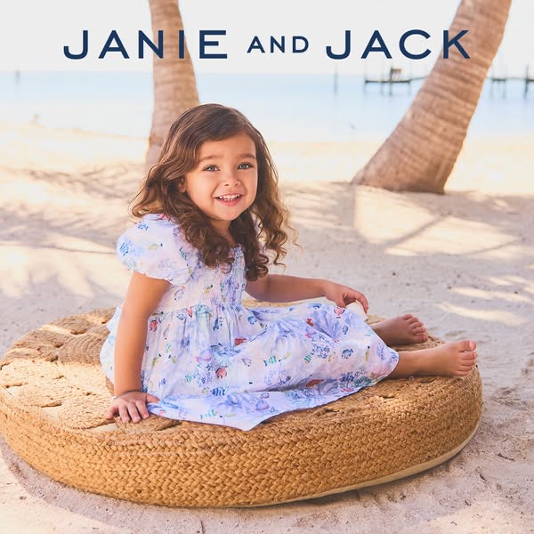 A lifestyle shot shows a young girl on a beach wearing a dress from Janie and Jack.