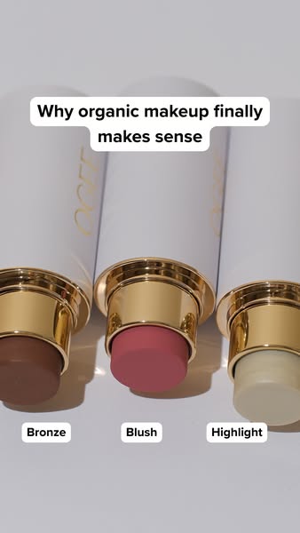 The ad showcases a trio of Ogee makeup sticks (bronzer, blush, and highlighter) and questions why organic makeup finally