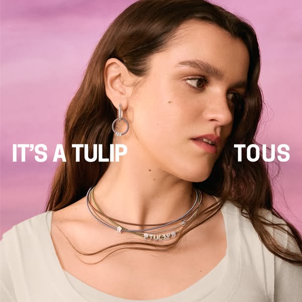 An image ad for Tous jewelry featuring a woman wearing the jewelry with the headline 'It's a tulip Tous'.