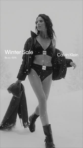 This ad for Calvin Klein features a woman in a bra and underwear set walking in the snow. The ad promotes a winter sale.