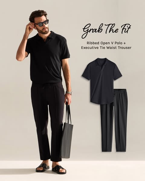 This image features a man wearing a matching black shirt and pants set with a pair of black sandals. The image also cont