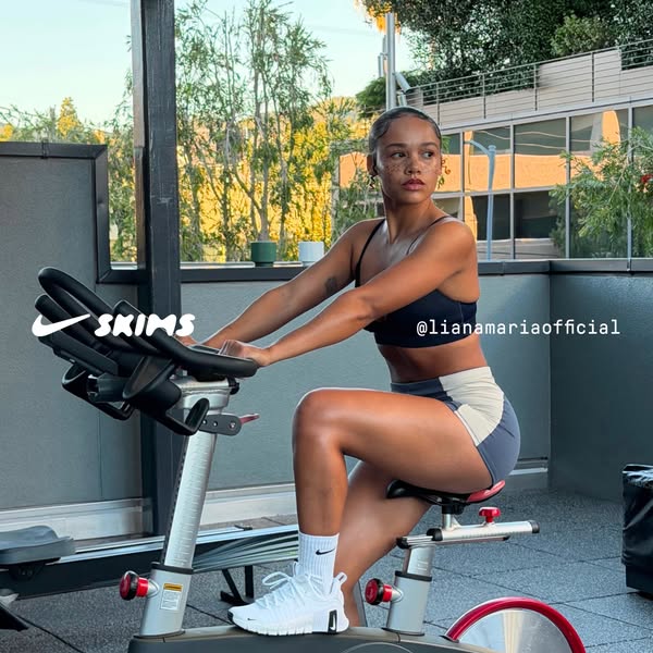 This ad features a woman on an exercise bike. She is wearing SKIMS apparel, and is tagged in the photo. The ad aims to c