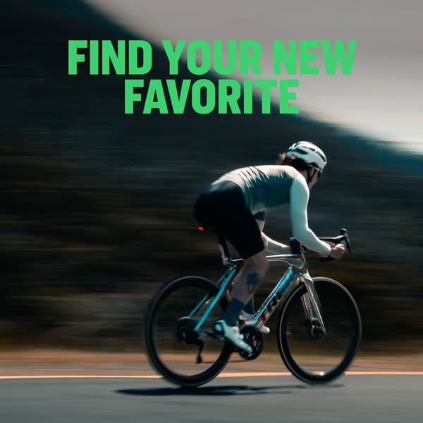 This image ad shows a person riding a road bike on a sunny day.