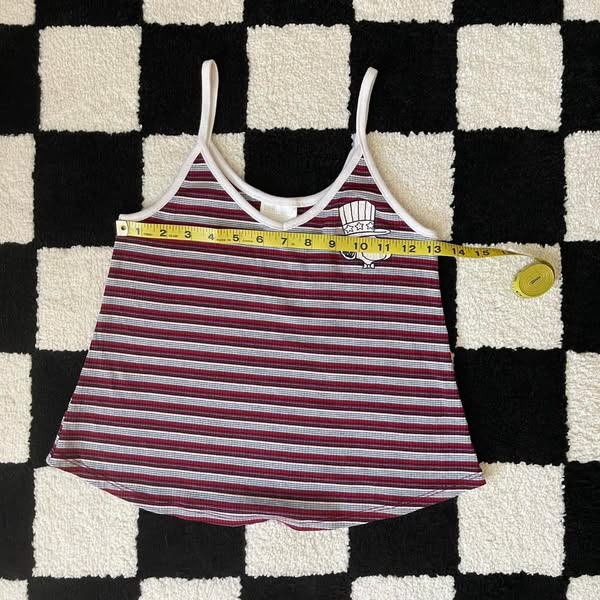 An ad featuring a striped tank top and a measuring tape to show the width of the item.