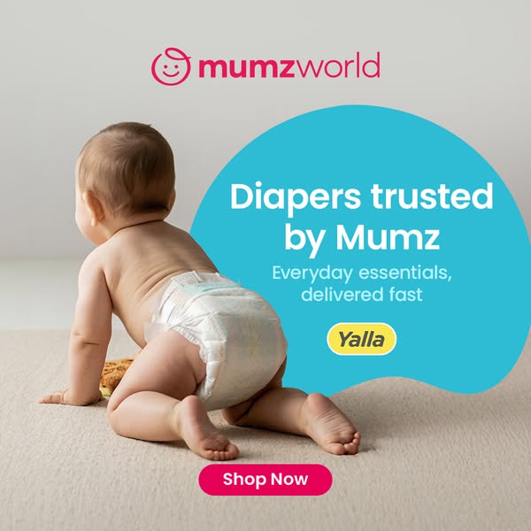 An ad for Mumzworld diapers featuring a baby crawling on a beige carpet. The ad highlights that their diapers are truste