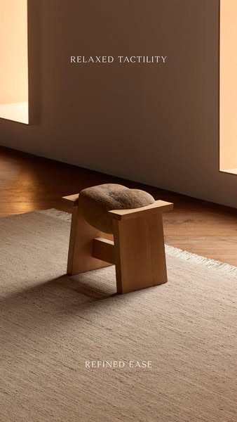This ad features a minimalist, naturally-toned interior scene with a simple wooden stool and a textured cushion, highlig
